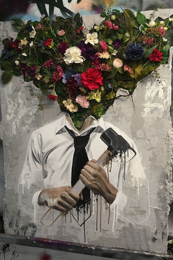 A person with flowers blooming in p[lace of their head, and a hammer in their hands.